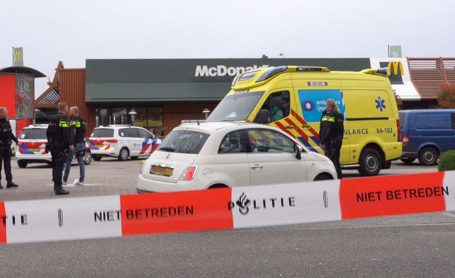 Police officers stand guard in front of a McDonald's restaurant, after two people were killed when a gunman opened fire at a McDonald's restaurant as reported by police and Dutch media, in Zwolle, north of Netherlands. - AFP Pic