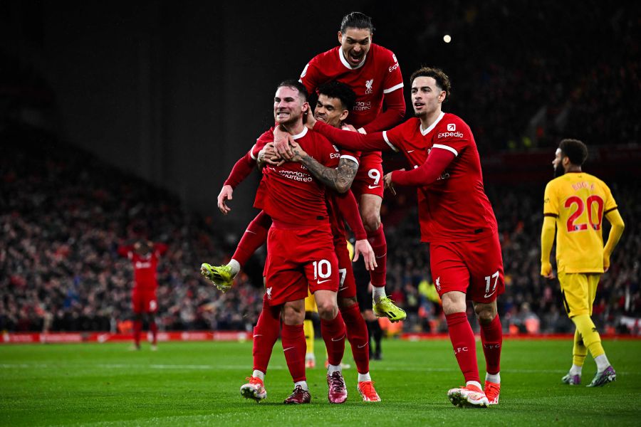 Liverpool's Argentinian midfielder #10 Alexis Mac Allister (L) celebrates with his teammates after scoring his team second gaol during the English Premier League football match between Liverpool and Sheffield United at Anfield in Liverpool, north west England on April 4, 2024.- AFP pic