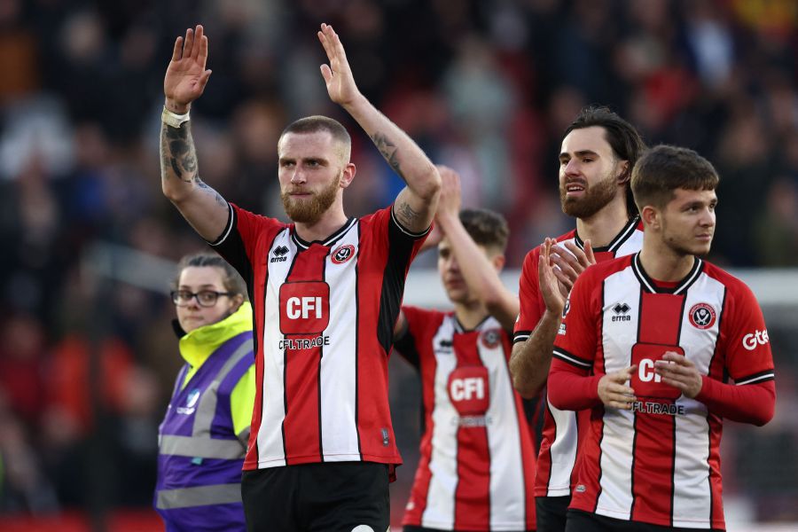 Sheffield United's English-born Scottish striker #09 Oli McBurnie (L) and teammates celebrate their draw on the pitch after the English Premier League football match between Sheffield United and Chelsea. - AFP pic