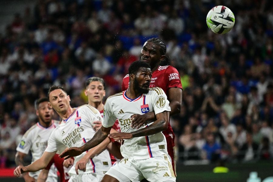 Lyon's English midfielder #98 Ainsley Maitland-Niles (front) fights for the ball with Brest's French defender #03 Lilian Brassier (R) during the French L1 football match beetween Olympique Lyonnais and Stade Brestois 29 at the Groupama Stadium in Decines-Charpieu, near Lyon, on April 14, 2024. - AFP pic