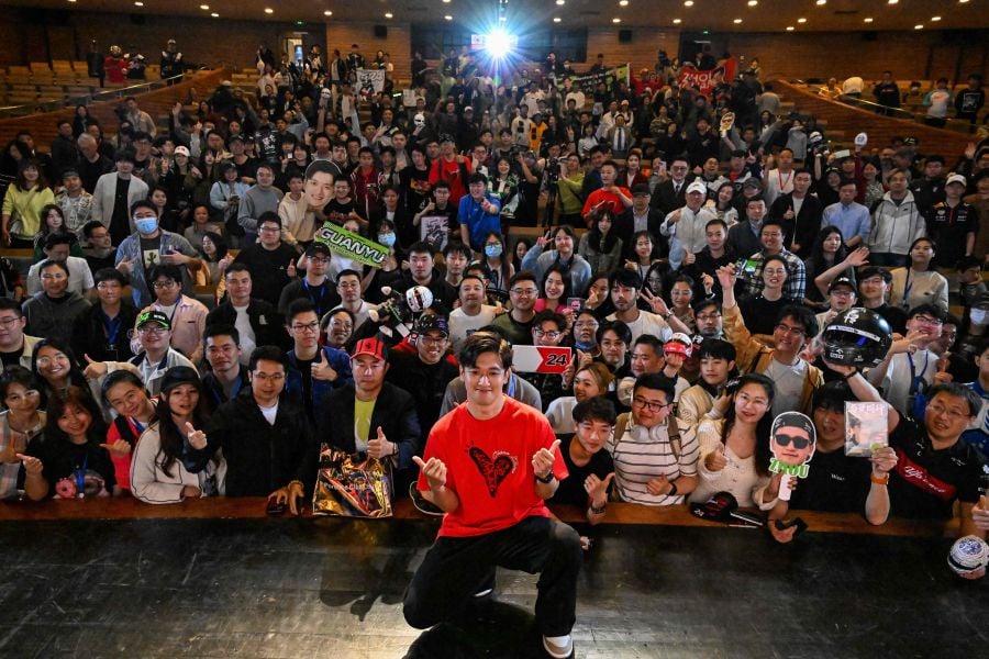 Formula 1 Kick Sauber's Chinese driver Zhou Guanyu poses for a pictures with his fans after the world premiere of the docu-film The First One, in Shanghai, on April 16, 2024. - AFP pic