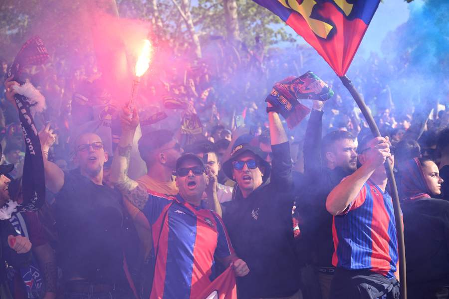 Barcelona supporters light flares and wave flags as they arrive to the stadium ahead of the UEFA Champions League quarter-final second leg football match between FC Barcelona and Paris SG at the Estadi Olimpic Lluis Companys in Barcelona on April 16, 2024.- AFP pic