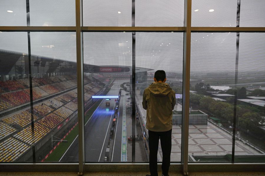 A man stands next to a window at the Shanghai International circuit ahead of the Formula One Chinese Grand Prix in Shanghai on April 17, 2024. - AFP pic