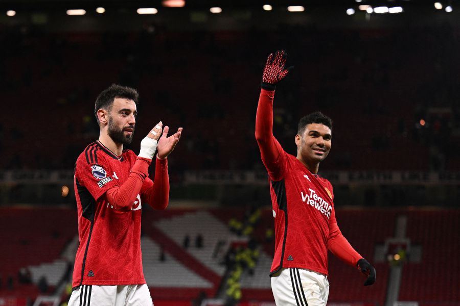Manchester United's Portuguese midfielder #08 Bruno Fernandes (L) and Manchester United's Brazilian midfielder #18 Casemiro applauds the fans following the English Premier League football match between Manchester United and Sheffield United at Old Trafford in Manchester, north west England, on April 24, 2024. - AFP pic