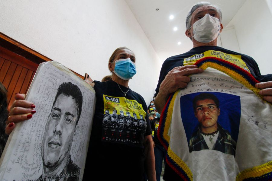 Relatives of a victim hold posters with his portrait during a hearing organized by the Special Jurisdiction for Peace (JEP) in Ocana, Colombia. - AFP Pic