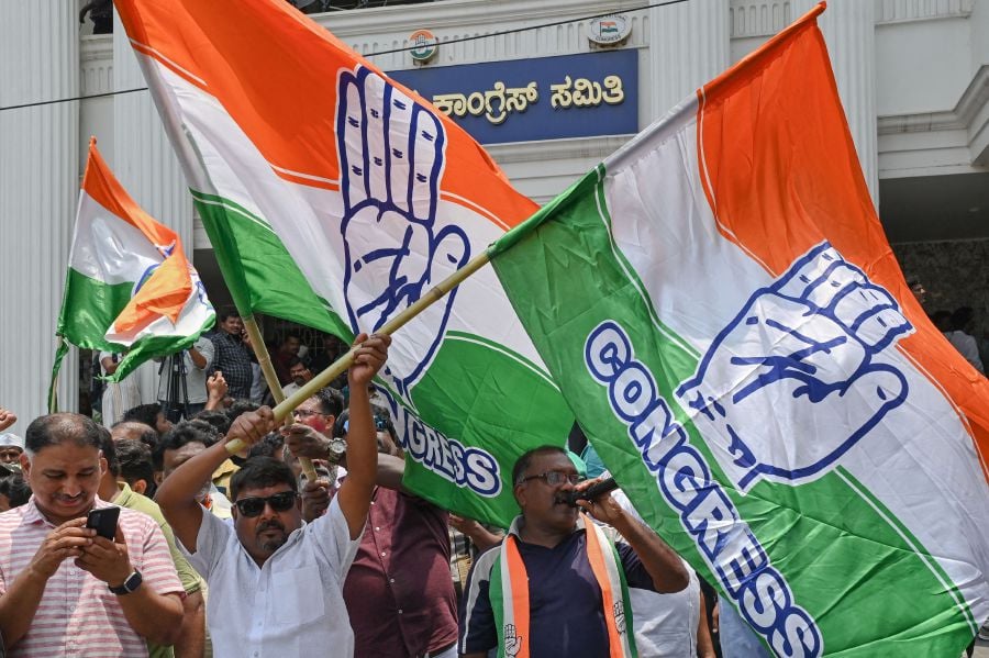 Congress supporters celebrate the party's victory in the Karnataka state legislative assembly election in front of the Karnataka Pradesh Congress Committee (KPCC) office in Bengaluru on May 13, 2023. - AFP Pic