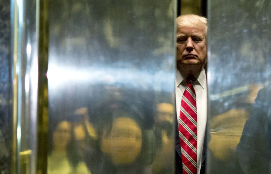 (FILES) In this file photo taken on January 16, 2017 US President-elect Donald Trump boards the elevator after escorting Martin Luther King III to the lobby after meetings at Trump Tower in New York City. - The Trump Organization is being investigated in a "criminal capacity" as New York prosecutors advance their probe into former president Donald Trump's business dealings, the state attorney general announced Tuesday."We have informed the Trump Organization that our investigation into the organization is no longer purely civil in nature," a spokesman for Attorney General Letitia James' office said. "We are now actively investigating the Trump Organization in a criminal capacity, along with the Manhattan DA." (Photo by DOMINICK REUTER / AFP)