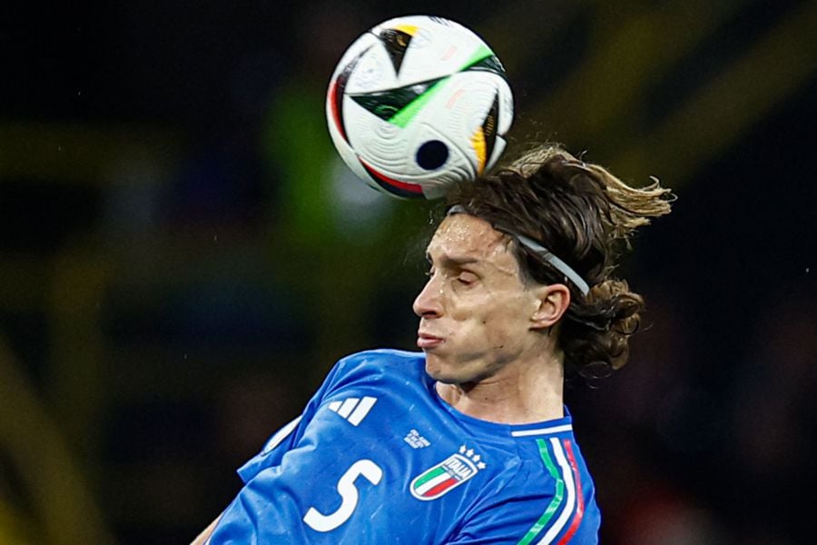Italy's defender #05 Riccardo Calafiori heads the ball during the UEFA Euro 2024 Group B football match between Italy and Albania at the BVB Stadion in Dortmund on June 15, 2024. - AFP PIC
