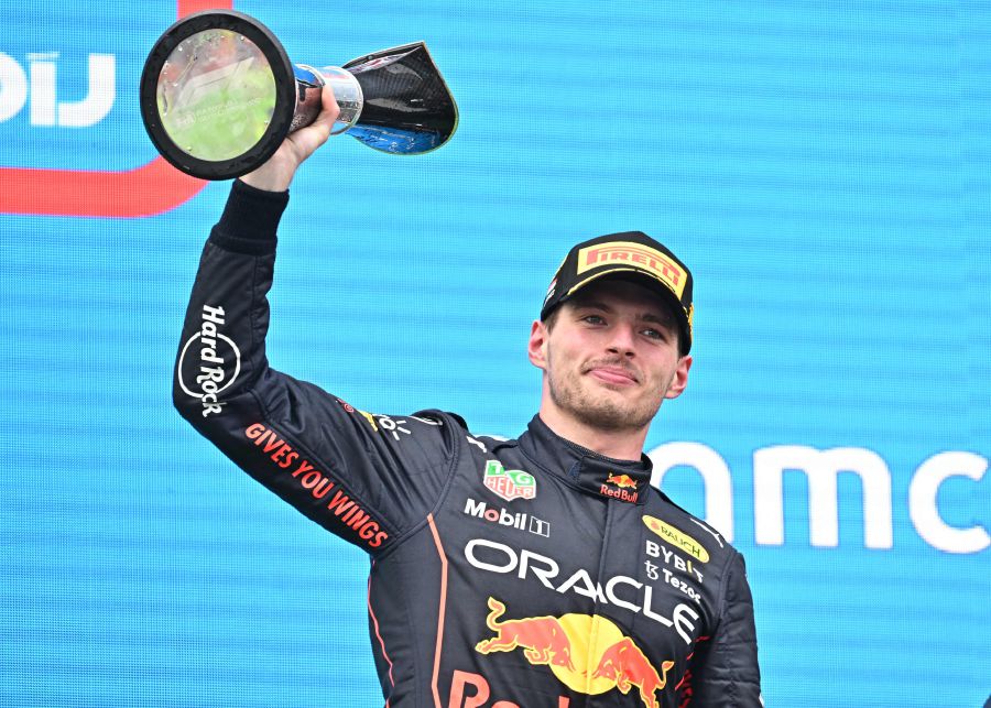 Winner Red Bull Racing's Dutch driver Max Verstappen celebrates with the trophy on the podium after the Formula One Hungarian Grand Prix. - AFP Pic
