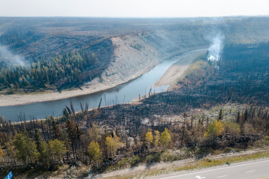 An aerial view shows charred remains on the side of the road beside the highway in Enterprise, Northwest Territories, Canada, on August 20, 2023. - AFP Pic