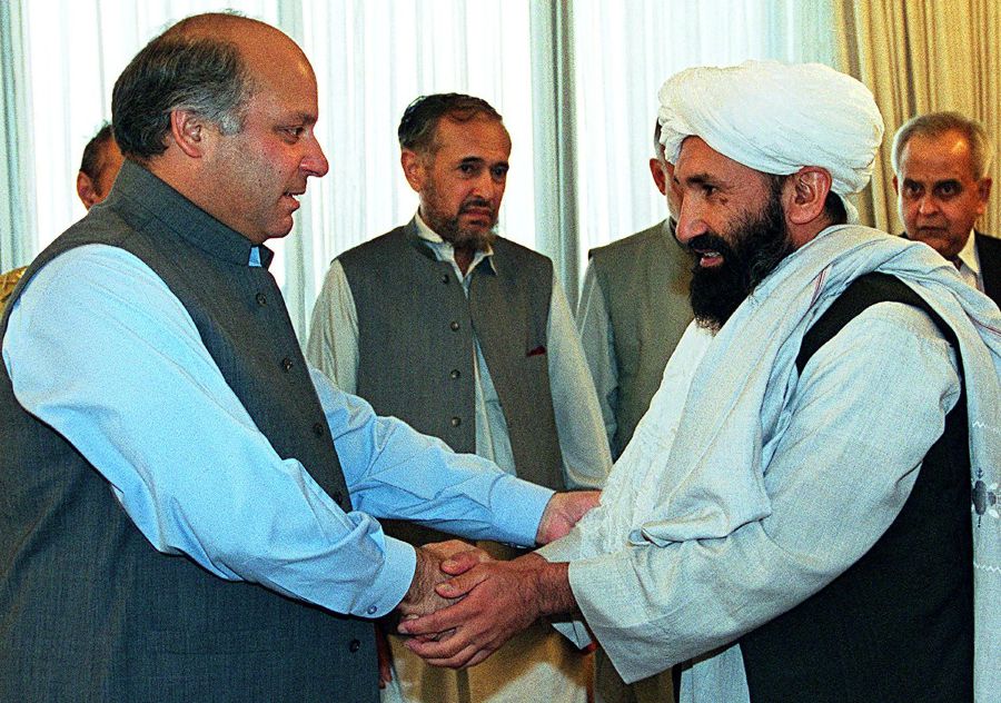 (FILES) In this file photo taken on August 26, 1999 Pakistani Prime Minister Nawaz Sharif receives Afghan Foreign Minister Mullah Mohammad Hassan Akhund (R) in Islamabad. - The Taliban announced Mullah Mohammad Hasan Akhund as the leader of their new government in Afghanistan on September 7, 2021. - AFP pic
