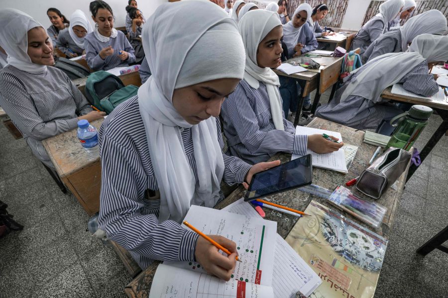 Students at a school run by the United Nations Relief and Works Agency for Palestine Refugees (UNRWA) use new electronic tablets in class, in Gaza City. (Photo by MOHAMMED ABED / AFP)