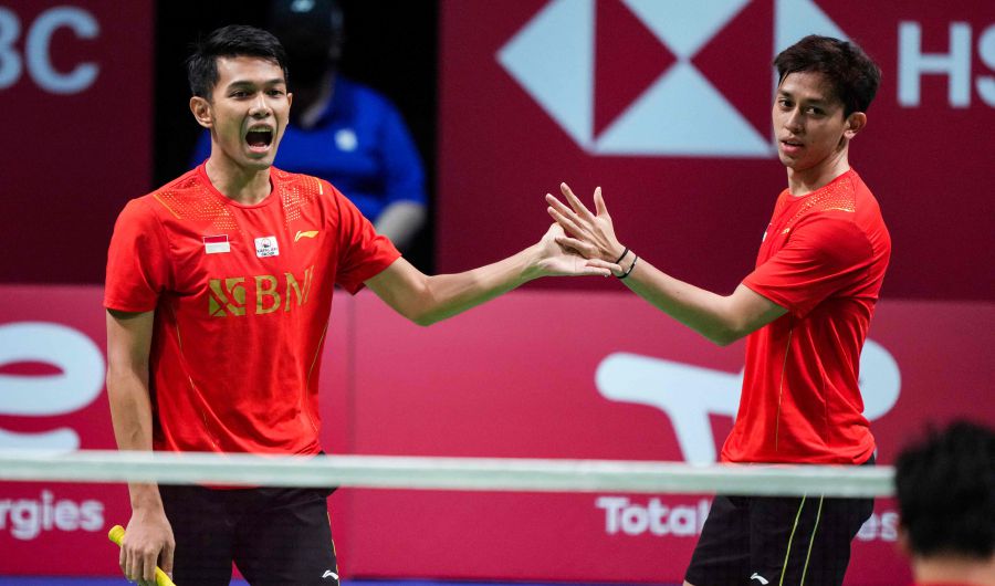 Indonesia's Fajar Alfian and Muhammas Rian Ardianto (R) react after winning a point during their men's s double match against China's He Ji Ting and Zhou Hao Dong (Both unseen) during the Thomas Cup men's team final match between China and Indonesia in Aarhus, Denmark. - AFP pic