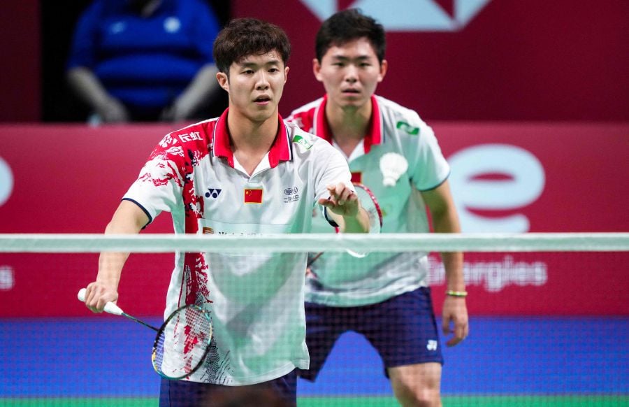 China's He Ji Ting (L) and Zhou Hao Dong compete during their men's s double match against Indonesia's Fajar Alfian and Muhammas Rian Ardianto (Both unseen) during the Thomas Cup men's team final between China and Indonesia in Aarhus, Denmark, on October 17, 2021. - AFP pic