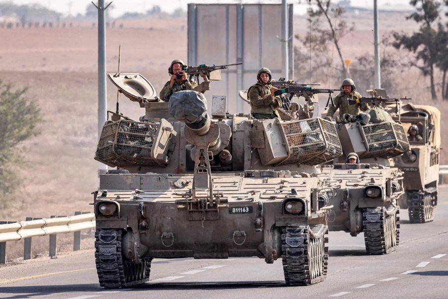 Israeli army self-propelled artillery howitzers move in a convoy with other vehicles along a road by the border with the Gaza Strip in southern Israel on November 1, 2023. - AFP Pic