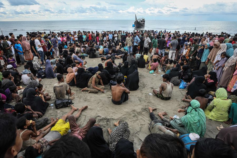 Newly arrived Rohingya refugees rest on the beach after the local community decided to temporarily allow them to land for water and food in Ulee Madon, Aceh province, Indonesia, on November 16, 2023.return to a boat. - AFP Pic