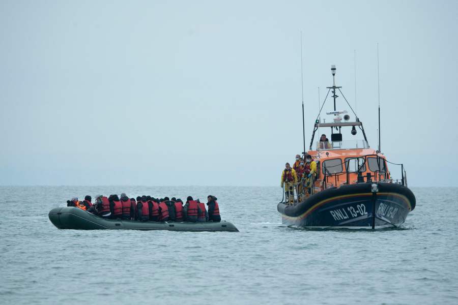 Migrants are helped by RNLI (Royal National Lifeboat Institution) lifeboat before being taken to a beach in Dungeness, on the south-east coast of England, after crossing the English Channel. - - AFP Pic
