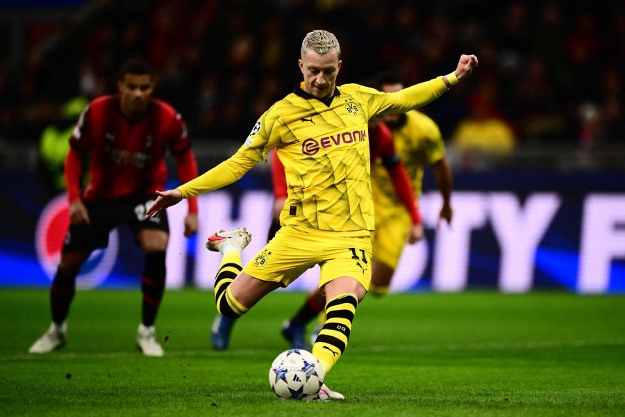 Dortmund's German forward #11 Marco Reus scores a penalty during the UEFA Champions League Group F football match between AC Milan and Borussia Dortmund. - AFP Pic
