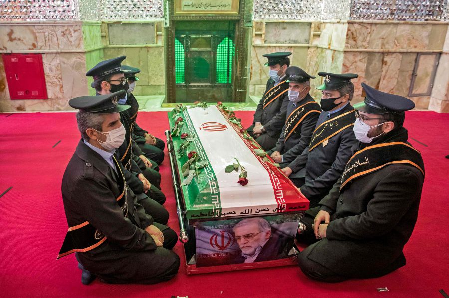 Members of Iranian forces pray around the coffin of slain nuclear scientist Mohsen Fakhrizadeh during the burial ceremony at Imamzadeh Saleh shrine in northern Tehran, on November 30, 2020. - Iran said Israel and an exiled opposition group used new and "complex" methods to assassinate its leading nuclear scientist, as it buried him in a funeral befitting a top "martyr". Fakhrizadeh died on November 27 after his car and bodyguards were targeted in a bomb and gun attack on a major road outside the capital, heightening tensions once more between Tehran and its foes. (Photo by HAMED MALEKPOUR / TASNIM NEWS / AFP)
