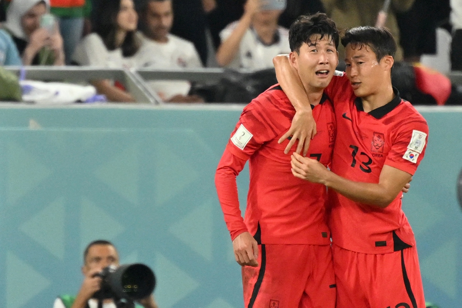 South Korea's midfielder #07 Son Heung-min and South Korea's midfielder #13 Son Jun-ho celebrate at the end of the Qatar 2022 World Cup Group H football match between South Korea and Portugal at the Education City Stadium in Al-Rayyan. - AFP Pic