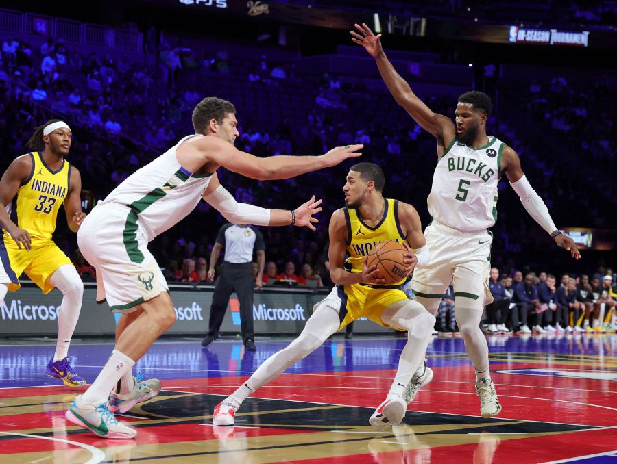 Tyrese Haliburton #0 of the Indiana Pacers is guarded by Brook Lopez #11 and Malik Beasley #5 of the Milwaukee Bucks in the first half of the East semifinal game of the inaugural NBA In-Season Tournament at T-Mobile Arena on December 07, 2023 in Las Vegas, Nevada. - AFP pic