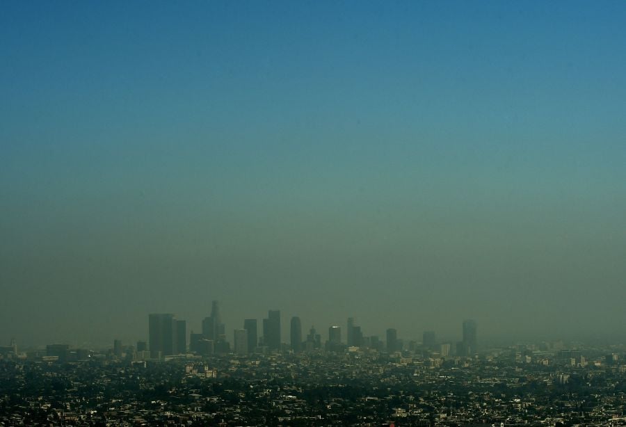 (FILES) A view of the Los Angeles city skyline as heavy smog shrouds the city in California on May 31, 2015.- AFP pic