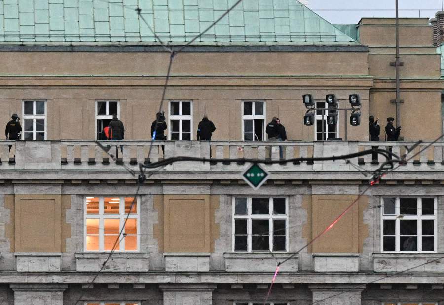 Armed police are seen on the balcony of the university in central Prague, on December 21, 2023. Czech police said Thursday a shooting in a university building in central Prague has left "dead and wounded people", without providing further details.- AFP pic