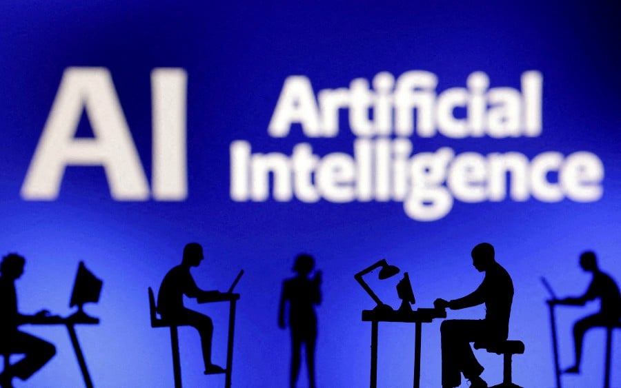 FILE PHOTO: Figurines with computers and smartphones are seen in front of the words "Artificial Intelligence AI" in this illustration taken, February 19, 2024. - REUTERS pic