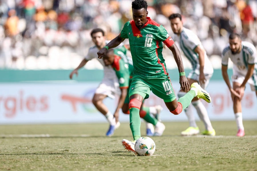 Burkina Faso's forward #10 Bertrand Traore scores his team's second goal from the penalty spot during the Africa Cup of Nations (CAN) 2024 group D football match between Algeria and Burkina Faso at Stade de la Paix in Bouake. - AFP pic