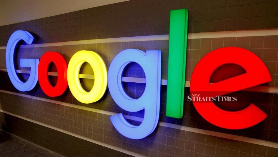 An illuminated Google logo is seen inside an office building. REUTERS/Arnd Wiegmann//File Photo