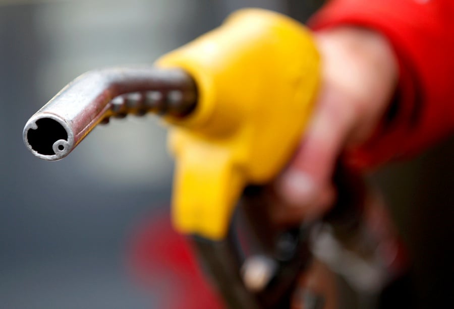 A petrol station attendant prepares to refuel a car. REUTERS/Max Rossi/File Photo