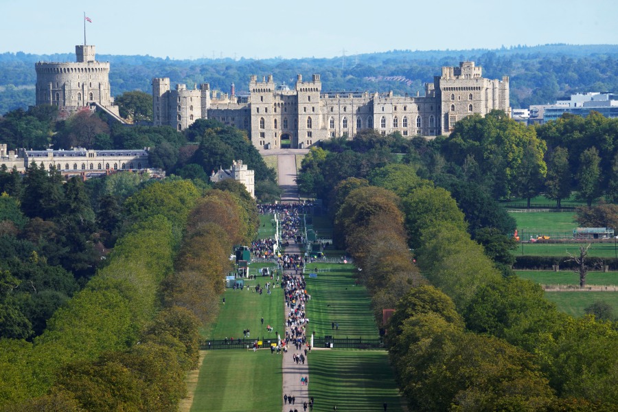 People make their way along the Long Walk towards Cambridge gate outside Windsor Castle to lay flowers for the late Queen Elizabeth II in Windsor, England. - AP Pic