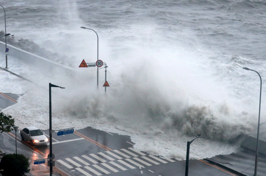 A wave caused by Typhoon Hinnamnor hits the waterfront in Busan, South Korea. (Photo by Yonhap/via REUTERS)