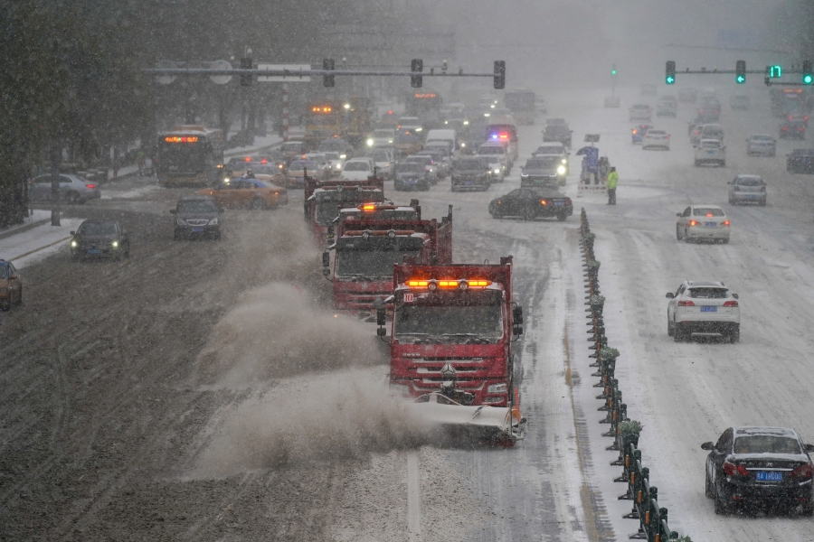 Snow removal vehicles move on a street amid a blizzard in Harbin, Heilongjiang province, China. (cnsphoto via REUTERS)