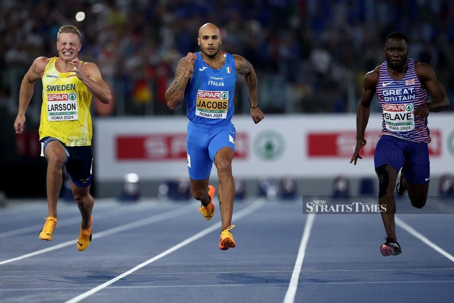 Italy's athlete Lamont Marcell Jacobs (centre) competes with Sweden's Henrik Larsson and Britain's Romell Glave (right) in the men's 100m final during the European Athletics Championships at the Olympic Stadium in Rome on Saturday. AFP PIC 