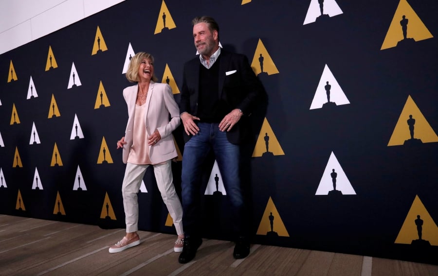 FILE PHOTO: Cast members John Travolta and Olivia Newton-John dance at a 40th anniversary screening of "Grease" at the Academy of Motion Picture Arts and Sciences in Beverly Hills, California, U.S., August 15, 2018. REUTERS/Mario Anzuoni/File Photo