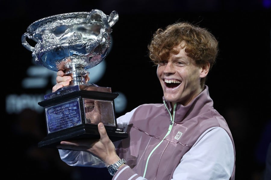 Italy's Jannik Sinner celebrates with the Norman Brookes Challenge Cup trophy after defeating Russia's Daniil Medvedev in the men's singles final match on day 15 of the Australian Open tennis tournament in Melbourne on January 29, 2024. - AFP pic
