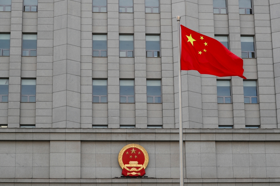 (FILE PHOTO) A Chinese national flag waves outside Beijing No. 2 Intermediate People's Court where Australian writer Yang Hengjun is expected to face trial on espionage charges, in Beijing, China. (REUTERS/Carlos Garcia Rawlins/File Photo)