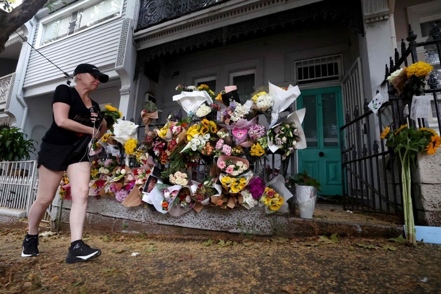 Floral tributes left by mourners are seen outside the shared residence of entertainment journalist Jesse Baird in the Sydney suburb of Paddington. (Photo by Saeed KHAN / AFP)