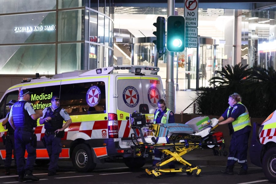 Paramedics move a stretcher with medical equipment outside the Westfield Bondi Junction shopping mall after a stabbing incident in Sydney. (Photo by David GRAY / AFP)