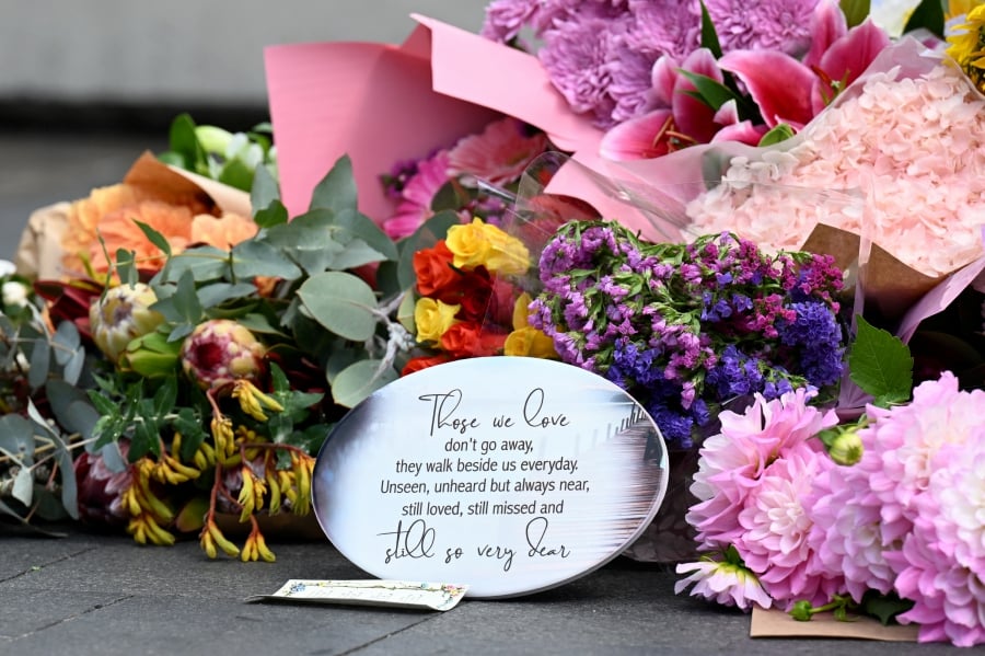 Flowers are laid by members of the public as they pay their respect for victims of Saturday's mass stabbing at Bondi Junction, Sydney, Australia. (AAP Image/Dean Lewins via REUTERS)