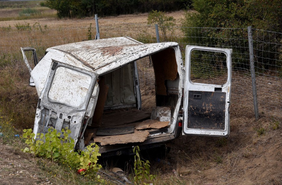 The crashed vehicle is pictured at the scene of an accident on August 13, 2022, on the A6 freeway at the Kittsee border crossing, northeastern Austria. - A people smuggler rolled over with his overcrowded van while trying to escape a police check on the northeastern freeway (A6) at the Kittsee border crossing. Three people were killed in the accident.  - AFP pic