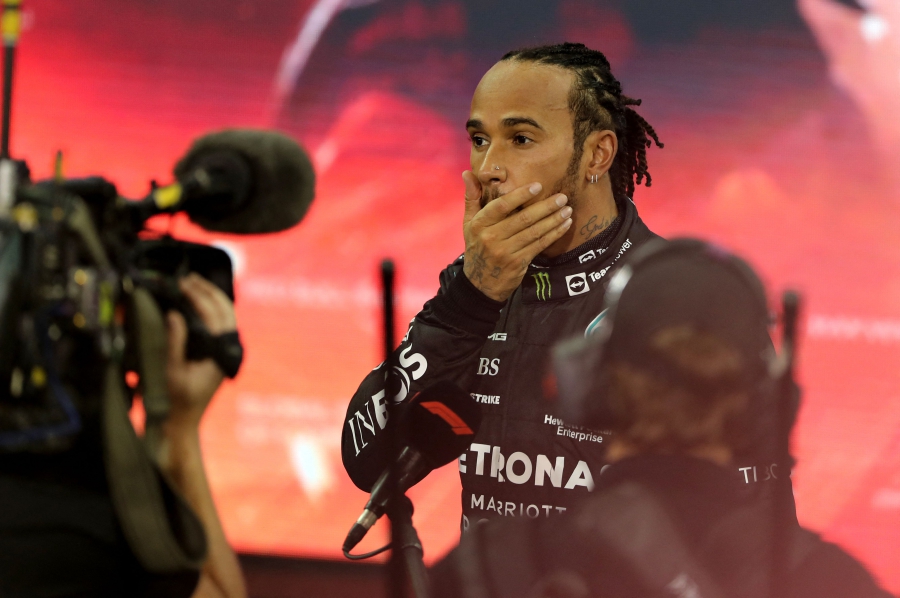 Second-placed Mercedes' British driver Lewis Hamilton reacts in the parc ferme of the Yas Marina Circuit after the Abu Dhabi Formula One Grand Prix on December 12, 2021. - Max Verstappen became the first Dutchman ever to win the Formula One world championship title when he won a dramatic season-ending Abu Dhabi Grand Prix at the Yas Marina circuit on December 12, 2021. The Red Bull driver won his 10th race of the season to finish ahead of seven-time champion Lewis Hamilton. (Photo by KAMRAN JEBREILI / POOL / AFP)