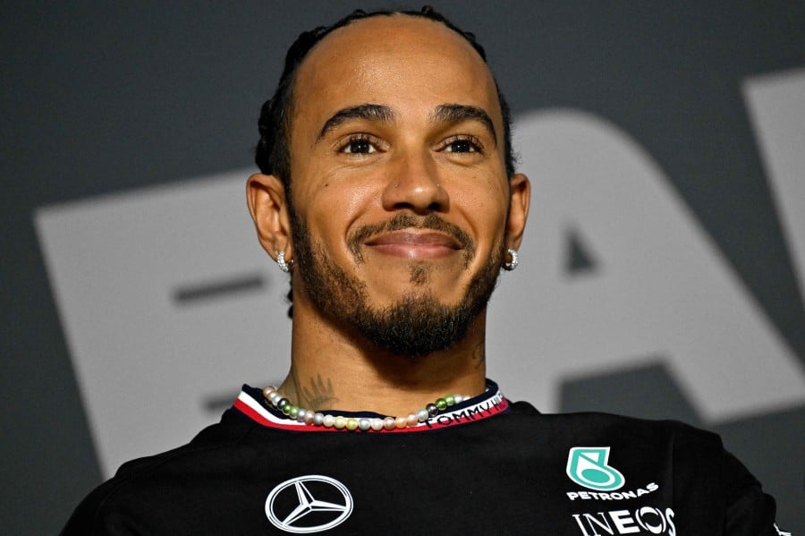 Mercedes' British driver Lewis Hamilton smiles during a press conference at the Bahrain International Circuit in Sakhir on February 28, 2024, ahead of the Bahrain Formula One Grand Prix. AFP PIC