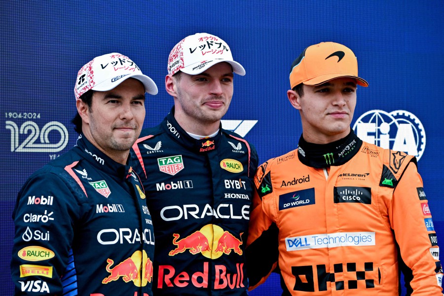 Pole position qualifier Red Bull Racing's Dutch driver Max Verstappen (center) poses with second-placed qualifier Red Bull Racing's Mexican driver Sergio Perez (left) and third-placed qualifier McLaren's British driver Lando Norris after the qualifying session for the Formula One Japanese Grand Prix race at the Suzuka circuit in Suzuka, Mie prefecture on April 6, 2024. - AFP pic