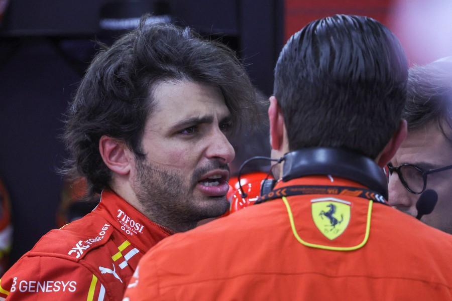 Ferrari's Spanish driver Carlos Sainz Jr talks to team members in the garage after the first practice session of the Saudi Arabian Formula One Grand Prix at the Jeddah Corniche Circuit in Jeddah. - AFP pic