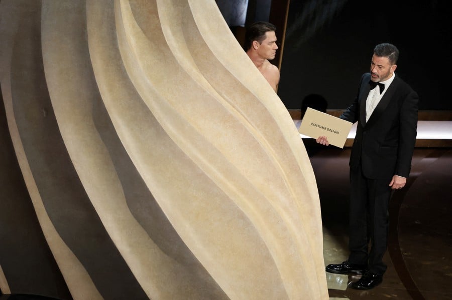 John Cena (Left) performs on stage with host Jimmy Kimmel during the presentation of the Oscar for Costume Design during the Oscars show at the 96th Academy Awards in Hollywood, Los Angeles, California, US, yesterday (March 10). — REUTERS