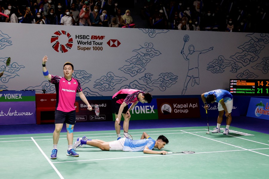 Malaysia’s Aaron Chia (L) and Soh Wooi Yik (2-L) ask for medical assistance for injured Yeremia Rambitan (2-R) of Indonesia as Pramudya Kusumawardana (R) pauses after their men's doubles quarterfinal match at the East Ventures Indonesia Open 2022 Badminton Tournament in Jakarta, Indonesia. - EPA PIC