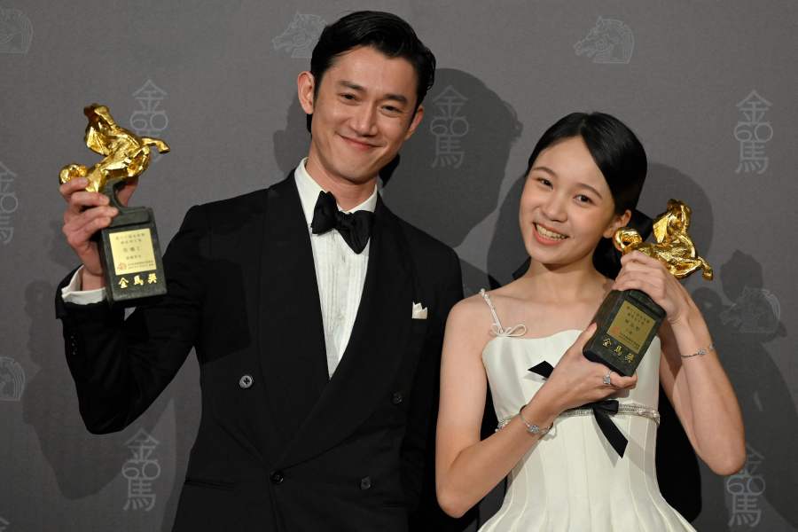 Taiwanese actress Audrey Lin (R) and actor Wu Kang-ren display trophies after winning the Best Leading Actress Award in the film ‘Trouble Girl’ and Best Leading Actor Award in the film ‘Abang Adi’; at the 60th Golden Horse Film Awards in Taipei on November 25. - AFP PIC