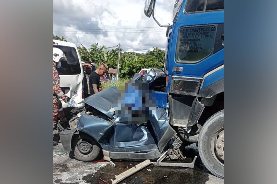 A crushed Perodua Kancil in which a 64-year-old man and his 36-year-old son were killed on the Kuching–Bau road. Pic courtesy of the Fire and Rescue Department